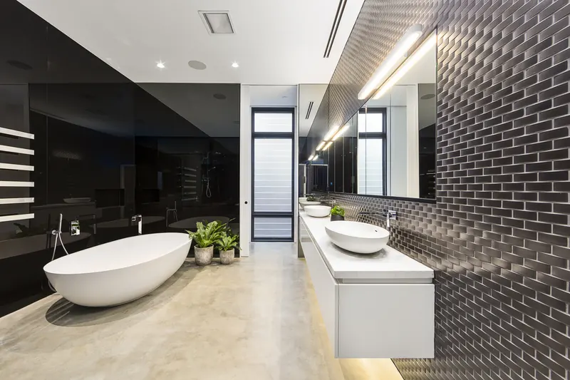 Black subway-tile feature wall with a floating vanity
