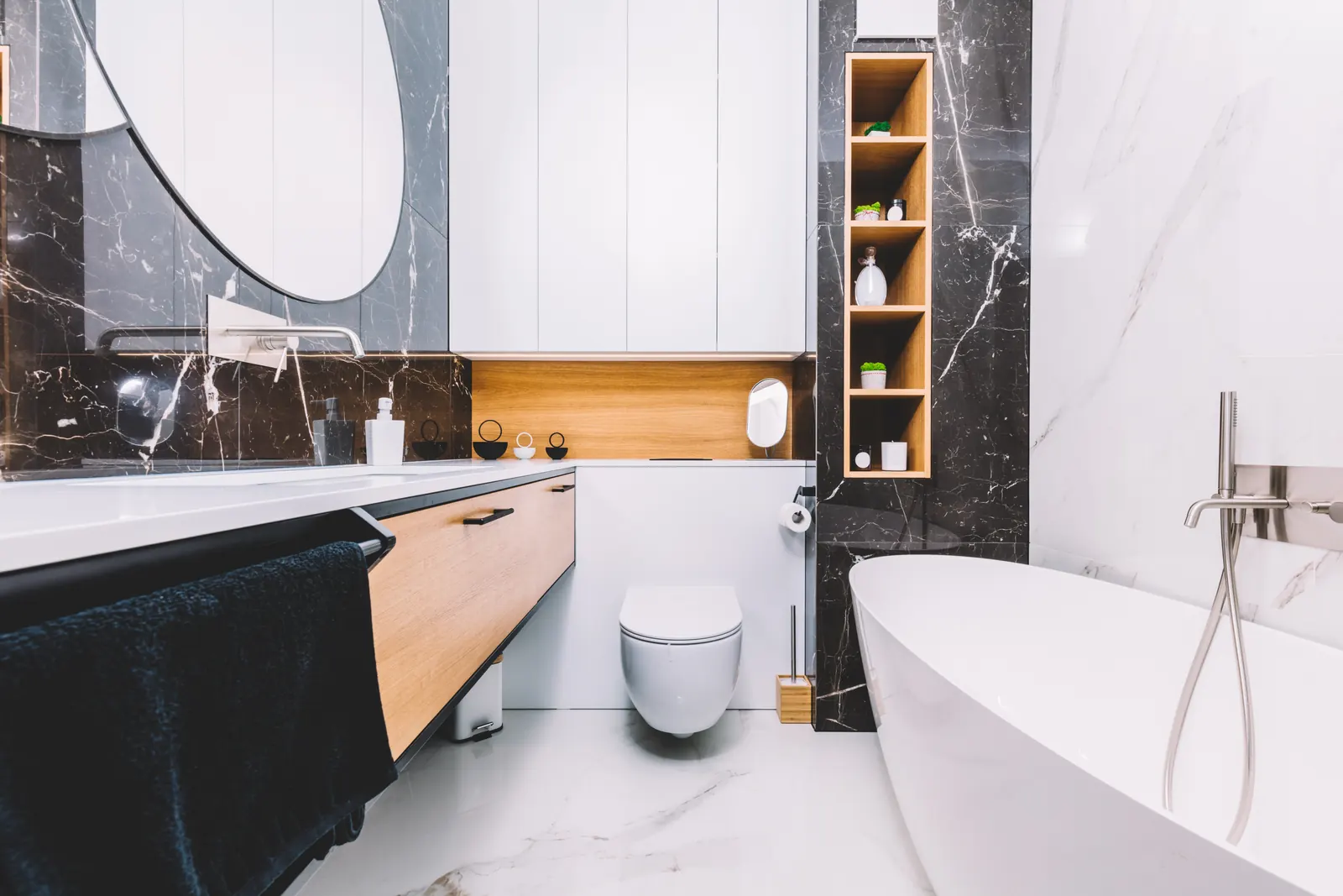 Walnut vanity with a black marble backsplash