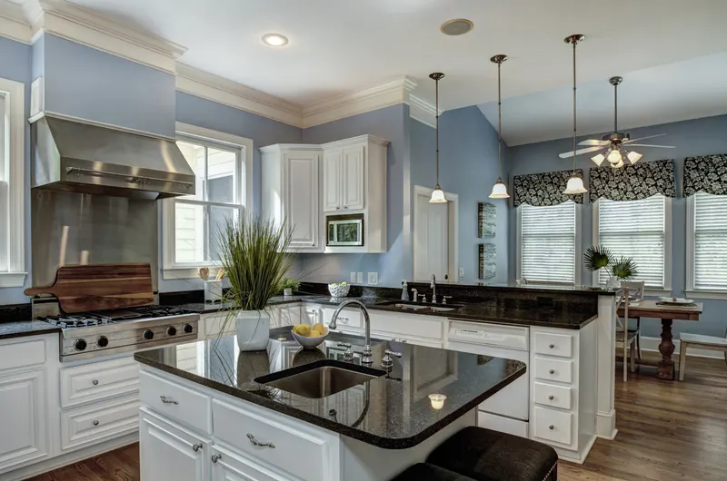 Black granite island under a vaulted ceiling