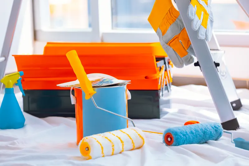 Rollers, brushes and drop cloths set out for a room