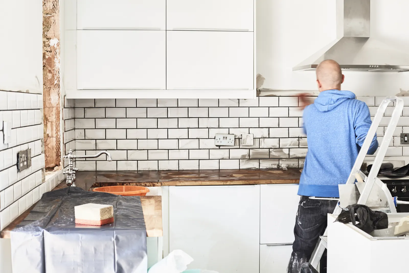 Subway-tile backsplash going up in a kitchen
