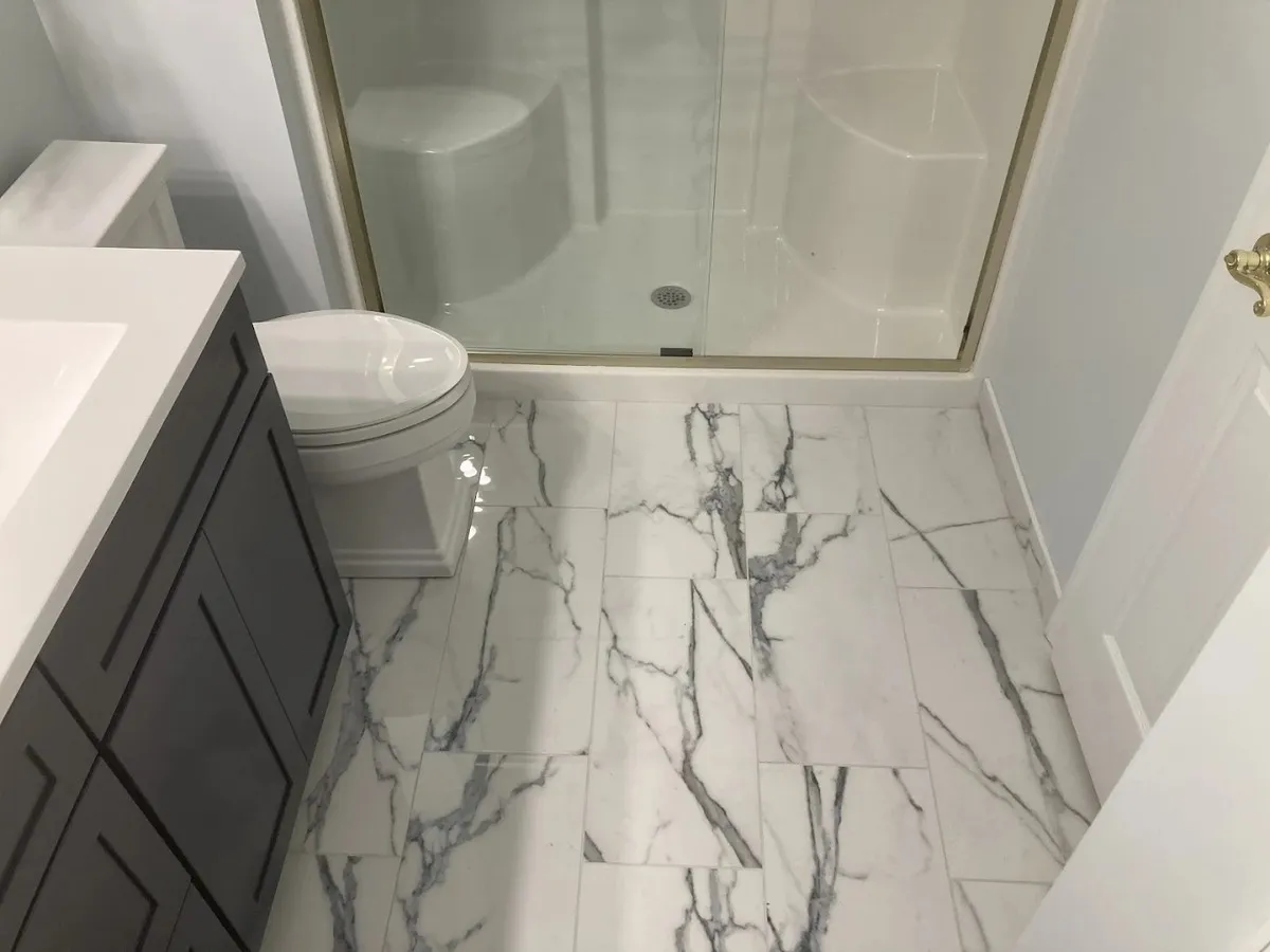 Bathroom remodeling — marble tile and glass shower — T.L. Drewes